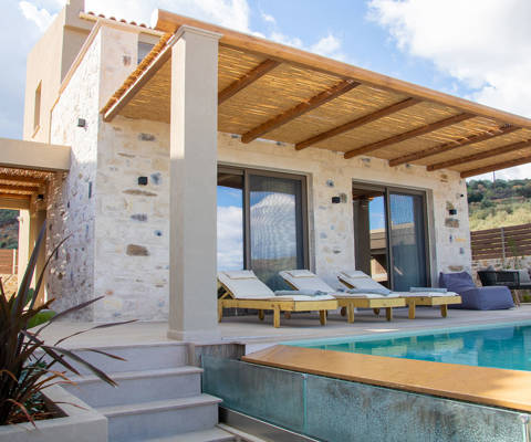 Outdoor pool area, having a comfortable siting room and sunbeds, side view