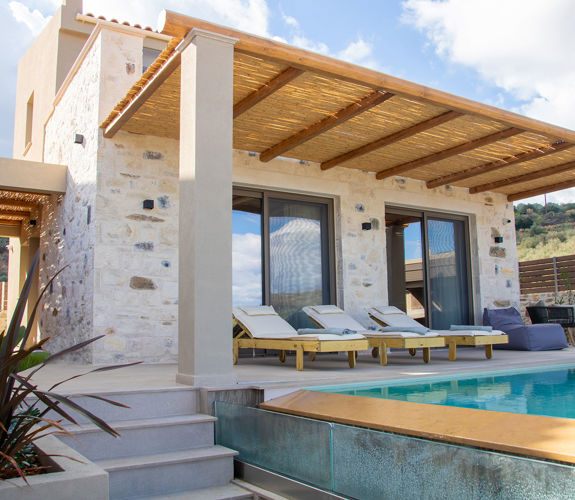 Outdoor pool area, having a comfortable siting room and sunbeds, side view