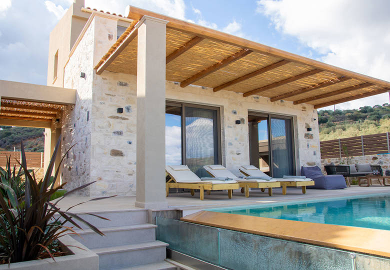 Outdoor pool area, having a comfortable siting room and sunbeds, side view