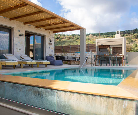 Outdoor pool area, having a dining table, a comfortable siting room and sunbeds, pool view