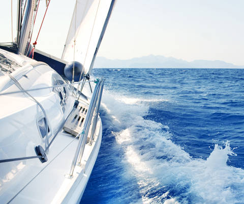 Sailing yacht cutting through the blue sea 