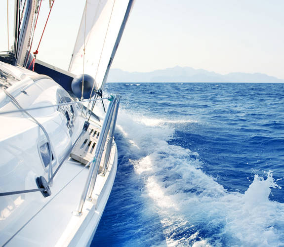 Sailing yacht cutting through the blue sea 