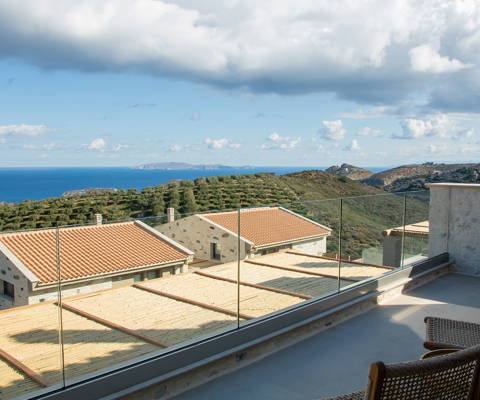 Outdoor area with seating at the edge of the veranda, offering stunning view.