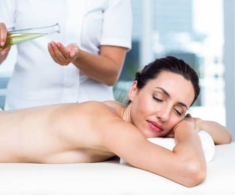 Woman enjoying a relaxing massage with essential oils at the spa